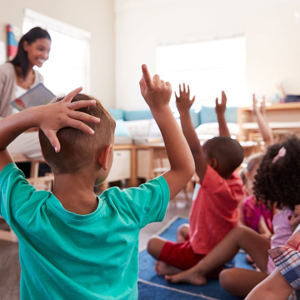 School classroom- children have their hands up